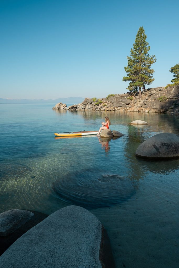 Girl sitting on rock at Secret Cove Lake Tahoe